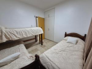 a bedroom with two bunk beds and a closet at Rincón del Sol en Albardón in Albardón