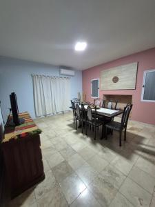 a dining room with a table and chairs and a fireplace at Rincón del Sol en Albardón in Albardón