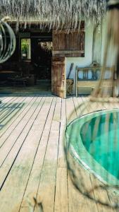 a house with a swimming pool and a thatch roof at Villa Fulô in Caraíva +188 photos
