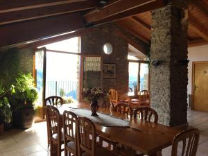 Casa Camp في Enviny: غرفة طعام مع طاولة وكراسي خشبية