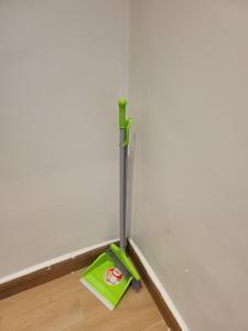 a mop sitting on the floor next to a wall at Ham Apartments in Kampala