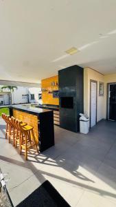 a kitchen with a table and chairs and a counter at Apto completo térreo 2quartos - praia e shopping in Rio das Ostras