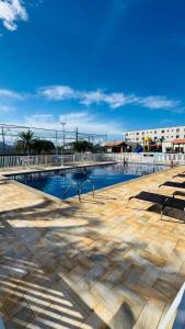 a swimming pool with a fence around it at Apto completo térreo 2quartos - praia e shopping in Rio das Ostras