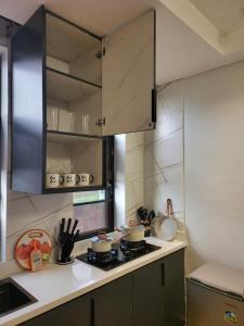 a kitchen with a stove and a counter top at Ham Apartments in Kampala