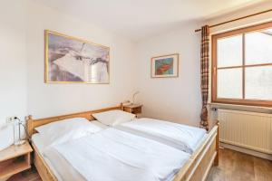 a bedroom with a bed and a window at Sonnenschein in Bad Hindelang