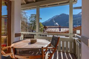 a table on a balcony with a view of a mountain at Sonnenschein in Bad Hindelang