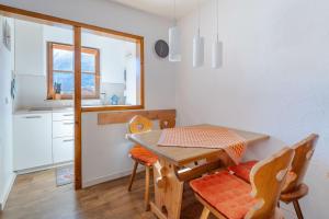 a kitchen with a table and chairs in a room at Sonnenschein in Bad Hindelang