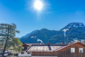 a view of a mountain with the sun in the sky at Sonnenschein in Bad Hindelang +7 photos