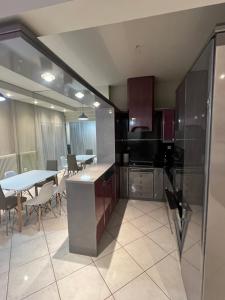 a kitchen and dining room with a table and chairs at A&S Luxury Apartment in Kavála