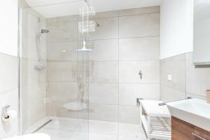 a bathroom with a shower and a toilet and a sink at Bergluft in Bad Hindelang +1 photo