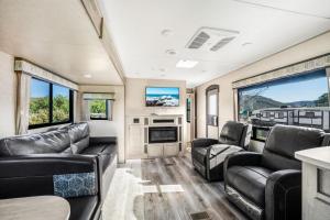 a living room with leather furniture in a rv at De Anza Springs Resort in Titus
