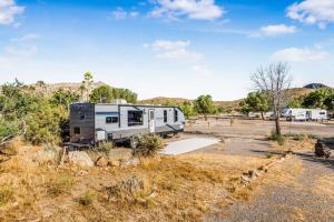 an rv parked in a parking lot in the desert at De Anza Springs Resort in Titus