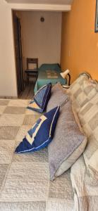 a bed with pillows sitting on top of it at Tu Lugar en Capilla Del Monte in Capilla del Monte