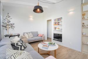 a living room with a couch and a table at Beachside on Hinemoa in Whangamata