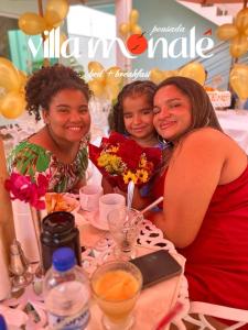 a group of three women sitting at a table at Pousada Villa Monale in Barreirinhas