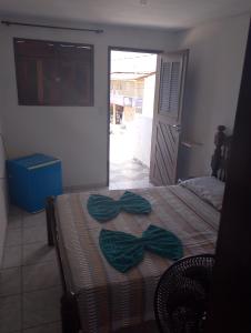 a bedroom with a bed with a bow on it at residencial portuguesa in Parnamirim