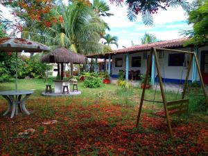a house with a yard with a swing and a table at residencial portuguesa in Parnamirim
