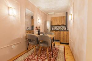 a kitchen with a table and chairs in a room at Mihail Residence - Old Town of Kavala in Kavála