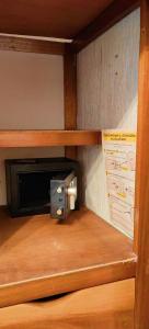 a microwave in a wooden cabinet with a paper holder at Casa Andy a 5 min del aeropuerto de Veracruz in Veracruz +9 photos