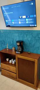 a coffee maker sitting on top of a wooden cabinet at Casa Andy a 5 min del aeropuerto de Veracruz in Veracruz