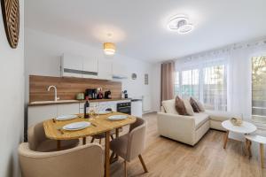a kitchen and living room with a table and chairs at 2 Bedroom Apartment for 6 with Private Parking - Elevator - High-Speed WiFi in Champigny-sur-Marne
