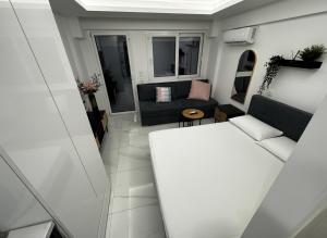 a small living room with a couch and a table at Blue Sea Nest in Paralia Katerinis