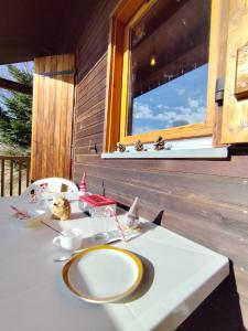 a table with a plate on it in front of a window at Le Doux Refuge in Ustou