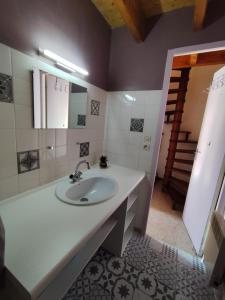 a bathroom with a white sink and a staircase at Le Doux Refuge in Ustou +31 photos