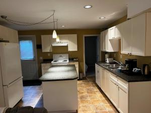 a kitchen with white cabinets and a counter top at Cozy 2BR Getaway Quiet & Relaxing in Langley