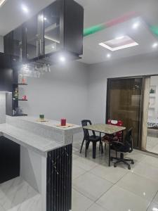 a kitchen with a counter and a table and chairs at Urban Oasis in Manta +2 photos