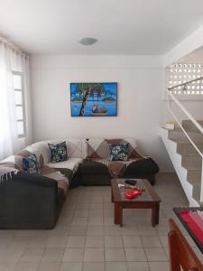a living room with a couch and a table at Bonito Itapuama Beach in Cabo de Santo Agostinho