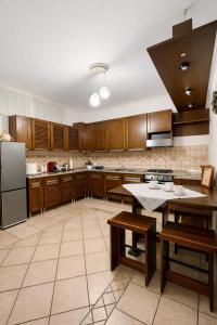 a large kitchen with wooden cabinets and a large island at The Mazzitellis Home in Nettuno