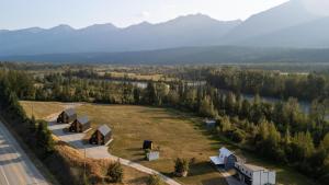 an aerial view of a house on a field next to a road at Hot Tub Nights & Mountain Mornings PÜR in Golden