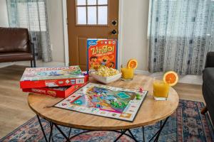 a table with a board game and snacks on it at NEW! Clearwater Gem, 10 Min to Beach, 2 Min to Downtown Dunedin, King Bed in Clearwater