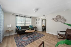 a living room with a couch and a table at NEW! Clearwater Gem, 10 Min to Beach, 2 Min to Downtown Dunedin, King Bed in Clearwater +74 photos