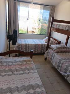 a room with two bunk beds and a window at Bonito Itapuama Beach in Cabo de Santo Agostinho +22 photos