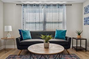 a living room with a couch and a table at NEW! Clearwater Gem, 10 Min to Beach, 2 Min to Downtown Dunedin, King Bed in Clearwater