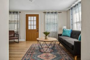 a living room with a couch and a table at NEW! Clearwater Gem, 10 Min to Beach, 2 Min to Downtown Dunedin, King Bed in Clearwater
