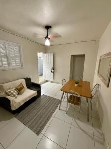 a living room with a couch and a table at Angra Prime Centro in Angra dos Reis