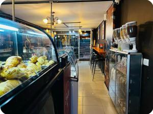 a bakery aisle with a display case of bread at Hospedaje Sary House in Bogotá