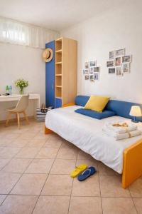 a bedroom with a large bed with a blue headboard at The Mazzitellis Home in Nettuno