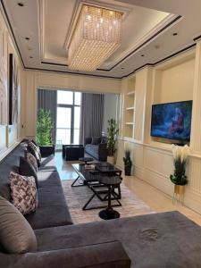 a living room with a couch and a table at Damac Al Jawharah Tower Versace Sea View شقة فرزاتشي بإطلالة بحرية برج داماك الجوهرة in Jeddah