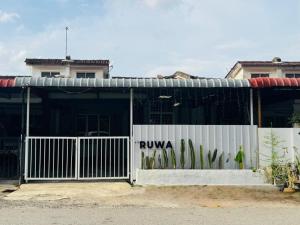 a building with a fence with a ryuza sign on it at Ruwa Homestay Jitra - 3BR, EV Port in Jitra