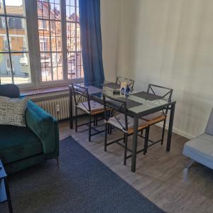 a dining room with a glass table and chairs at veeweyde in Brussels