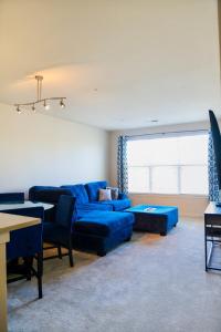 a living room with blue couches and a table at Cozy & inviting 2BD 2BTH Apt Home in Owings Mills