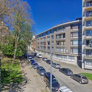 a parking lot with cars parked in front of a building at veeweyde in Brussels