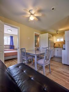 a living room with a table and chairs and a couch at Four Seasons Algonquin Cabins in Madawaska