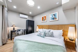 a bedroom with a large bed and a desk at The McCaul by Casa Hotels Near AGO Basement Suite in Toronto