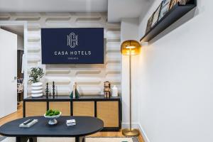 a room with a table and a sign on a wall at The McCaul by Casa Hotels Near AGO Basement Suite in Toronto +16 photos