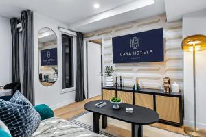 a living room with a couch and a table at The McCaul by Casa Hotels Near AGO Basement Suite in Toronto